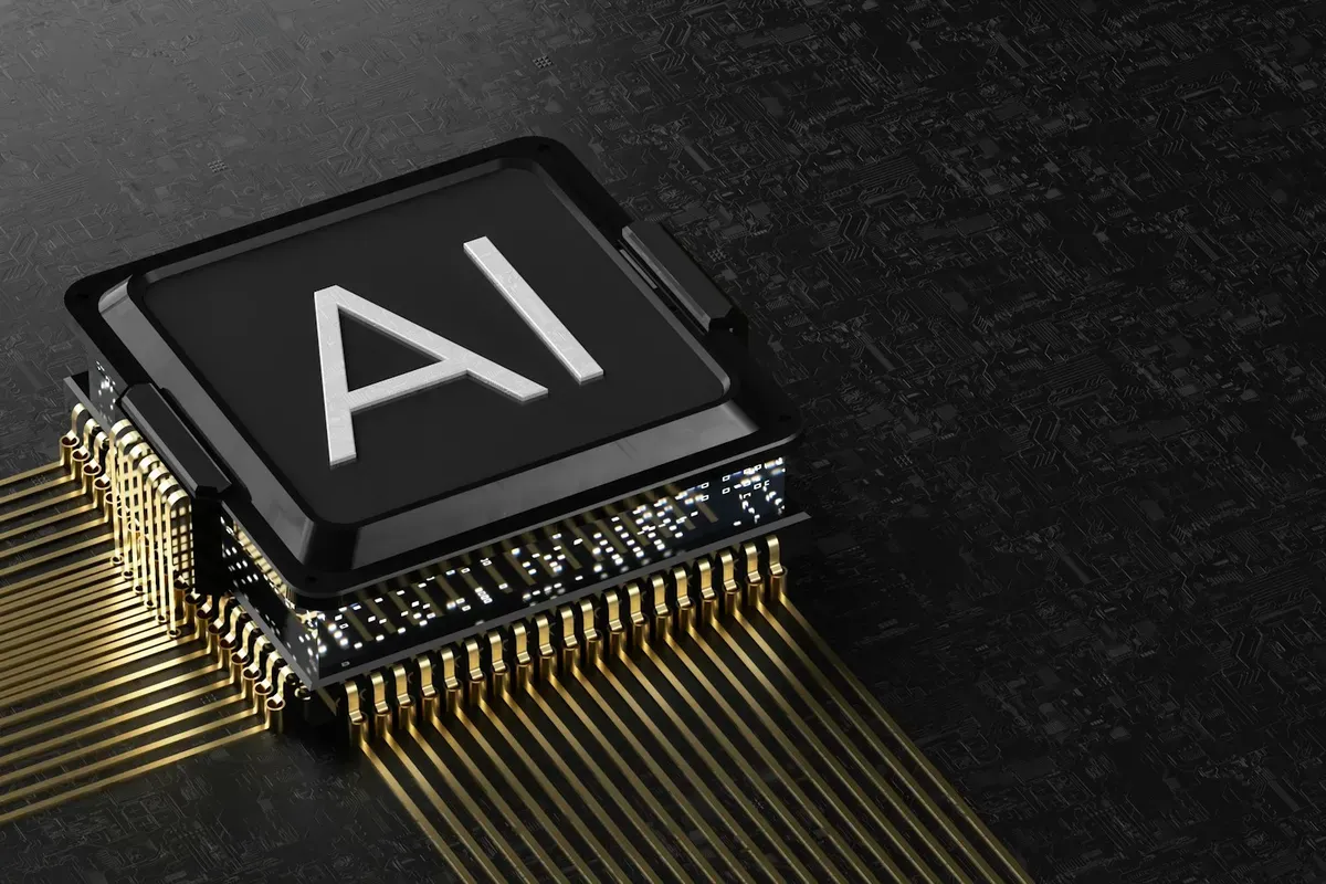 Close-up of a processor chip marked AI, with gold pins fanning out across a dark circuit board