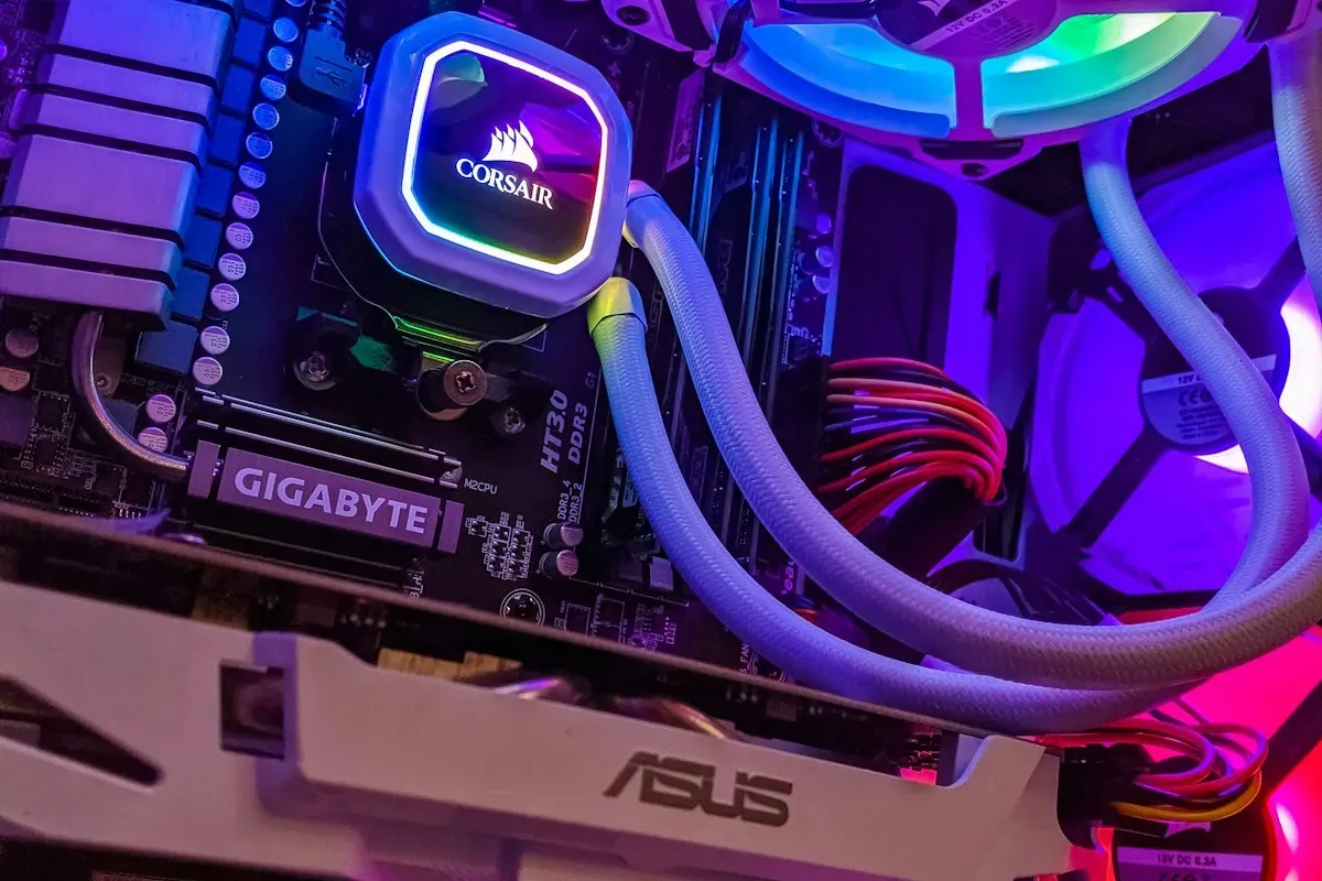 Inside a custom PC build with an RGB-lit liquid cooler, braided coolant tubes, and a graphics card